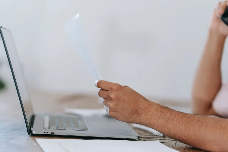 A UK landlord checking a rental statement against their records before completing the SA105 property pages