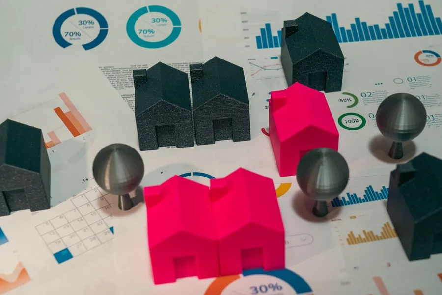Model houses set on printed financial charts, representing the rental income figures landlords must disclose to HMRC Model houses set on printed financial charts, representing the rental income figures landlords must disclose to HMRC