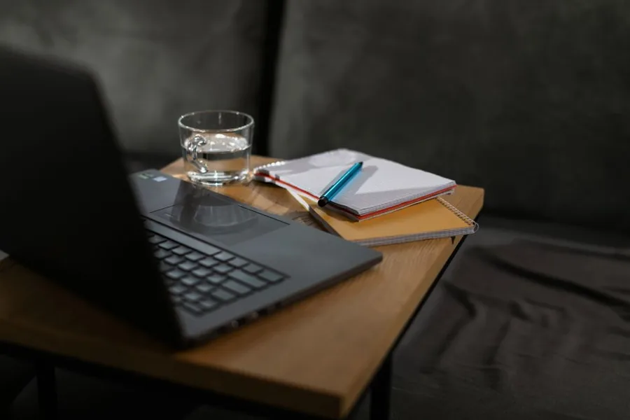 An accountant talking a client through their tax code and payroll paperwork at a desk An accountant talking a client through their tax code and payroll paperwork at a desk