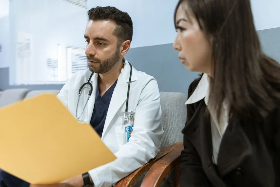 A locum doctor reviewing paperwork with an adviser to check IR35 status and which expenses are allowable