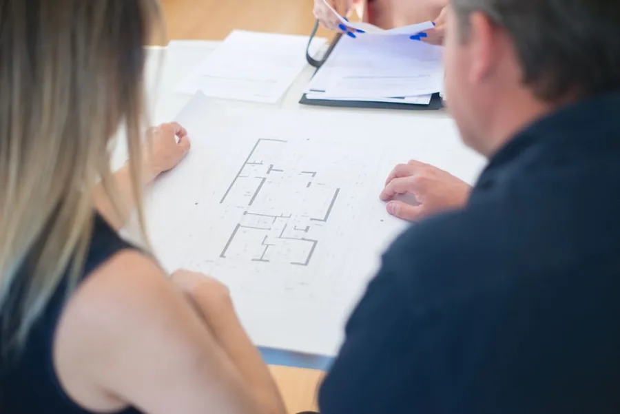 Construction business owners reviewing project plans while checking their CIS gross payment status ahead of the 2026 rules Construction business owners reviewing project plans while checking their CIS gross payment status ahead of the 2026 rules