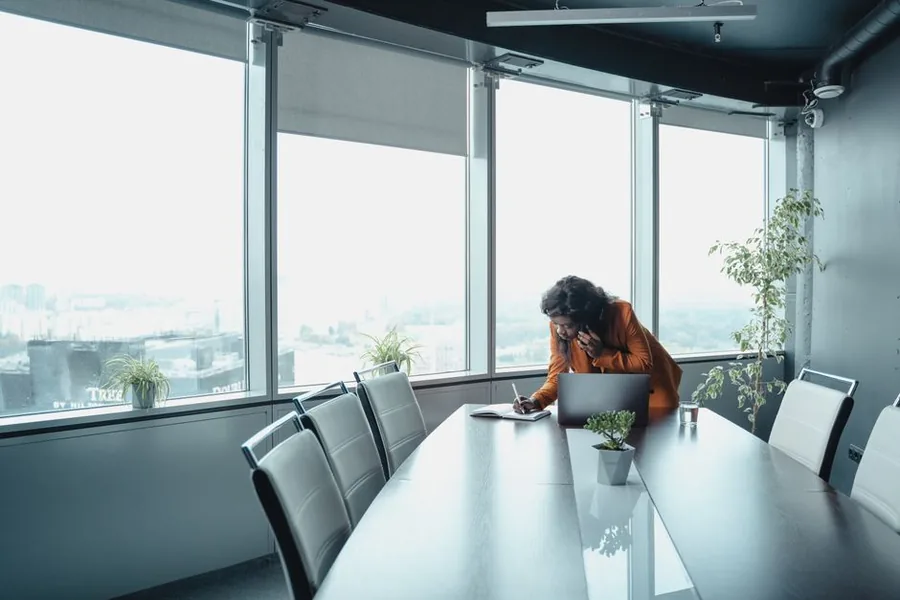 A company director working alone at a boardroom laptop, planning a tax efficient salary for the 2025/26 year A company director working alone at a boardroom laptop, planning a tax efficient salary for the 2025/26 year