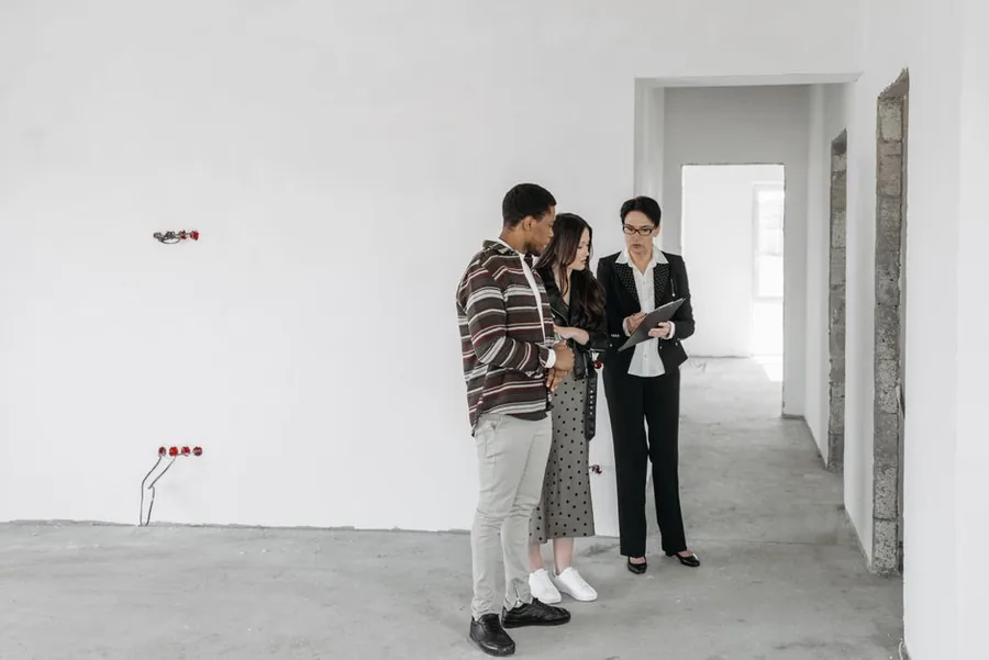 A letting agent reviewing rental property paperwork with landlords, the kind of records MTD for ITSA requires kept digitally A letting agent reviewing rental property paperwork with landlords, the kind of records MTD for ITSA requires kept digitally