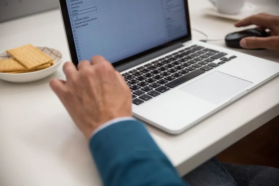 A business owner working in a spreadsheet on a laptop, the record-keeping format landlords can still use under MTD with digital links A business owner working in a spreadsheet on a laptop, the record-keeping format landlords can still use under MTD with digital links