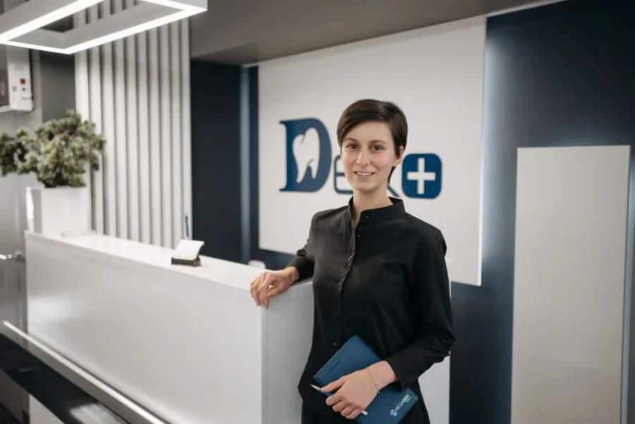 A practice owner at the reception of a modern UK dental clinic run through a limited company A practice owner at the reception of a modern UK dental clinic run through a limited company