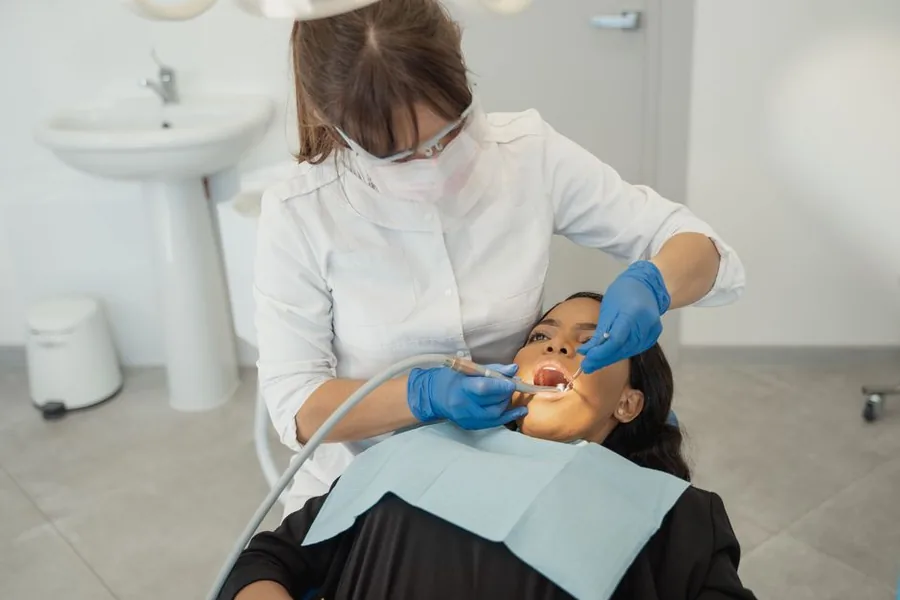 A UK dentist treating a patient in the chair, the kind of mixed NHS and private work that drives an income split A UK dentist treating a patient in the chair, the kind of mixed NHS and private work that drives an income split