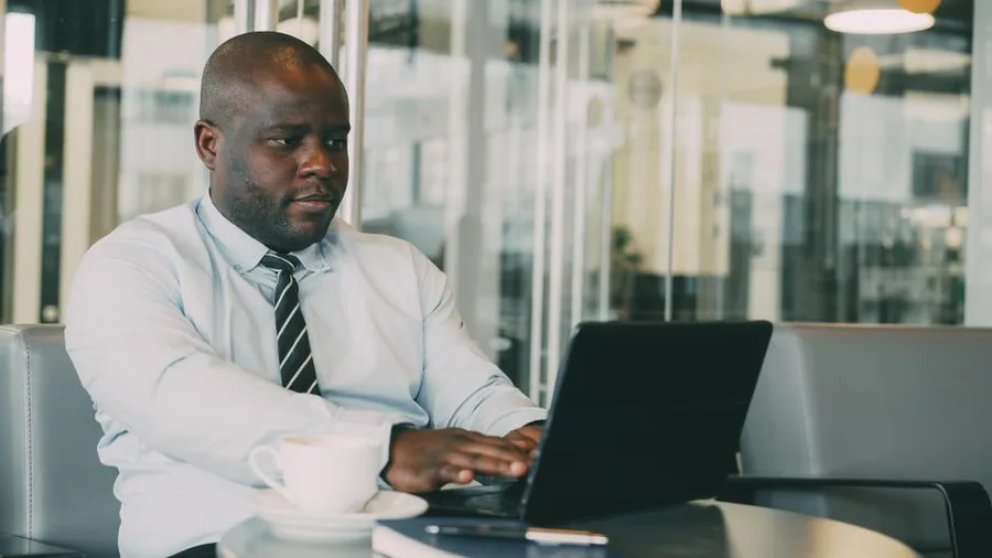 A UK online seller reviewing sales figures and tax obligations on a laptop from a modern office