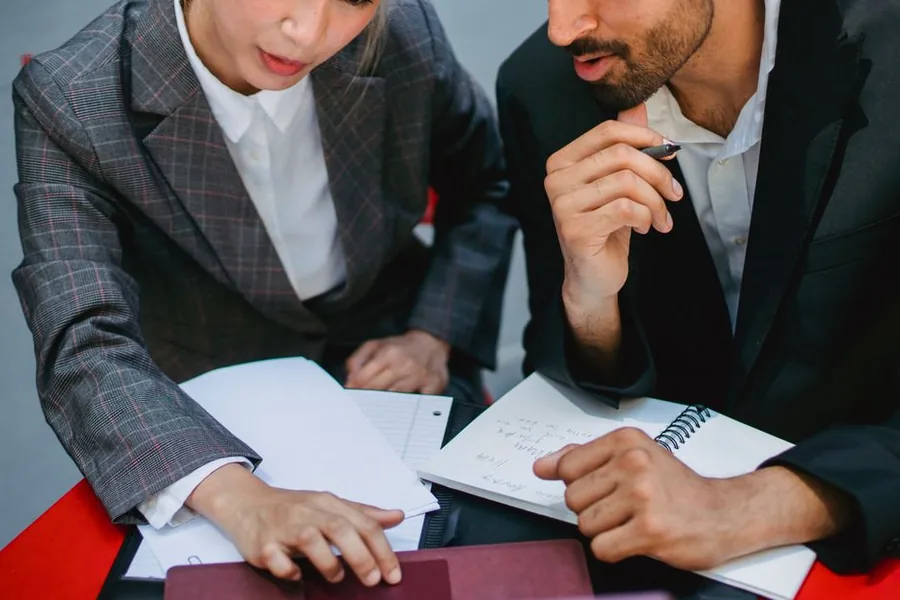 Two advisers reviewing an ecommerce seller's figures to identify reclaimable VAT on Amazon fees Two advisers reviewing an ecommerce seller's figures to identify reclaimable VAT on Amazon fees