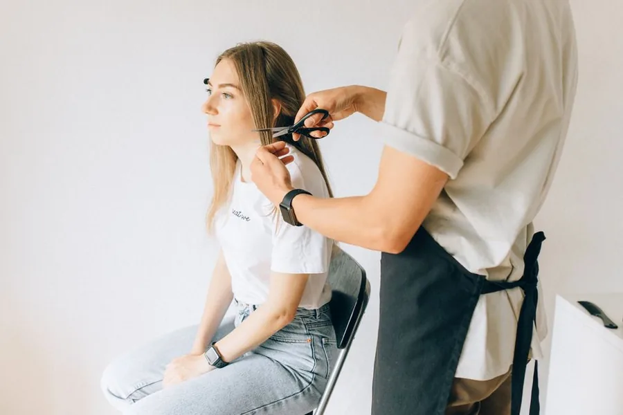 A salon stylist cutting a client's hair, the working reality behind choosing to employ staff or rent out chairs A salon stylist cutting a client's hair, the working reality behind choosing to employ staff or rent out chairs