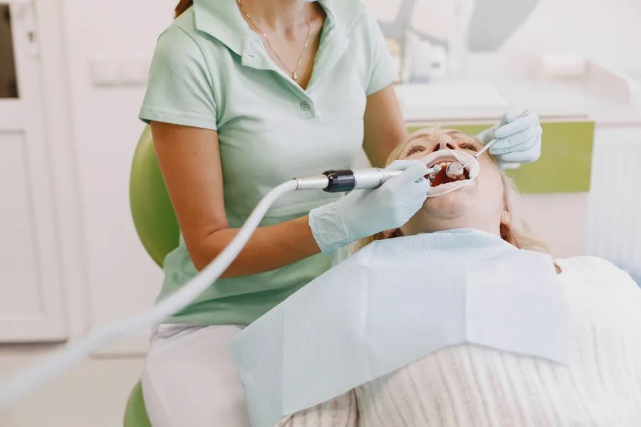 A self-employed dental hygienist demonstrating brushing on a teeth model between private patient appointments A self-employed dental hygienist demonstrating brushing on a teeth model between private patient appointments