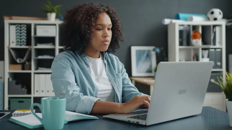 A self-employed professional working from a tidy home office desk, the setting for claiming working-from-home tax relief