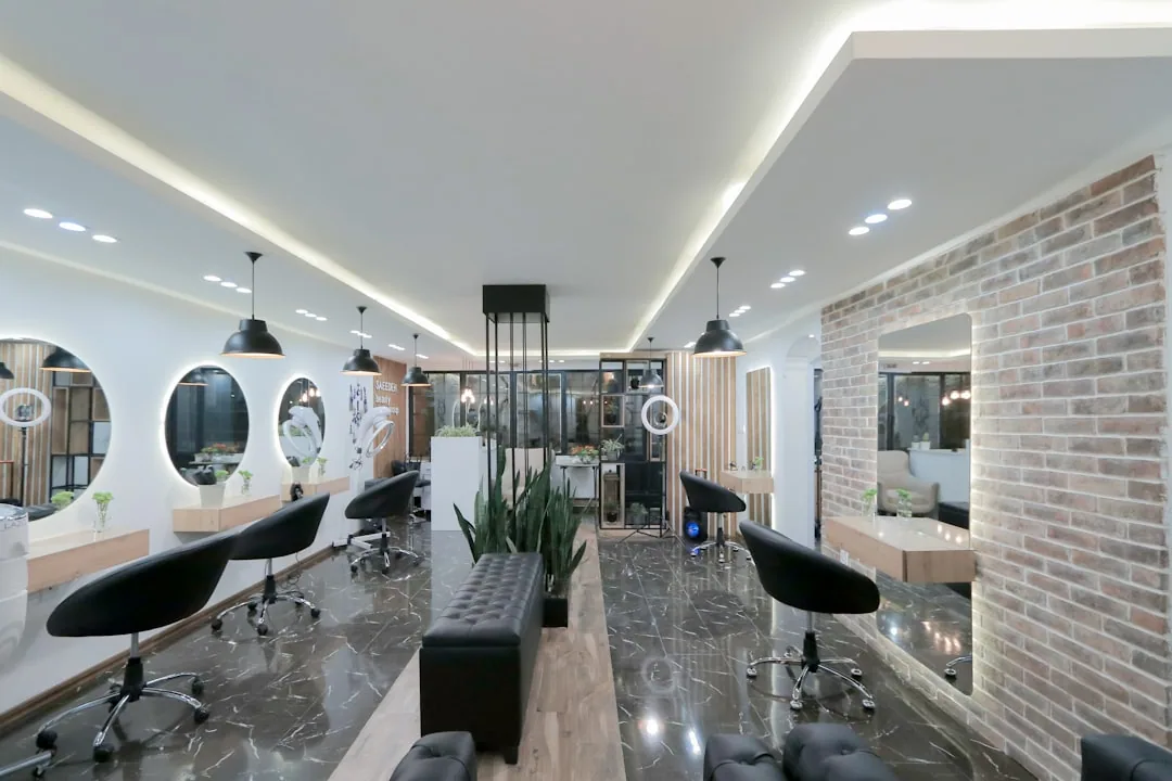 A hair salon owner handing over keys at the reception desk after agreeing the sale of the business