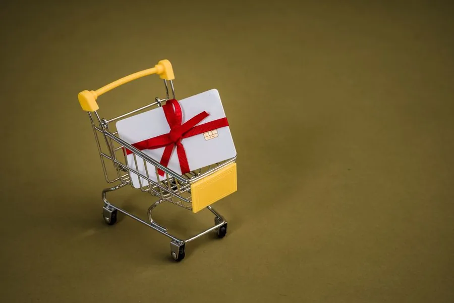A gift card sitting in a miniature shopping trolley, standing in for unredeemed Shopify gift card balances an online retailer carries as deferred revenue A gift card sitting in a miniature shopping trolley, standing in for unredeemed Shopify gift card balances an online retailer carries as deferred revenue