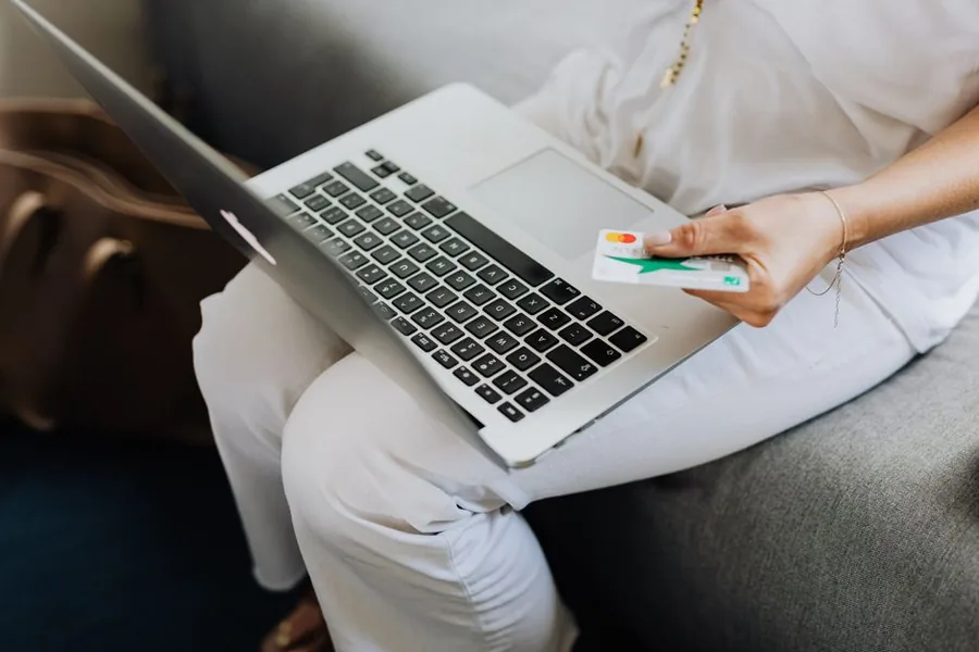 A shopper paying by card on a laptop, the kind of ecommerce sale that flows through a Shopify payout for VAT A shopper paying by card on a laptop, the kind of ecommerce sale that flows through a Shopify payout for VAT