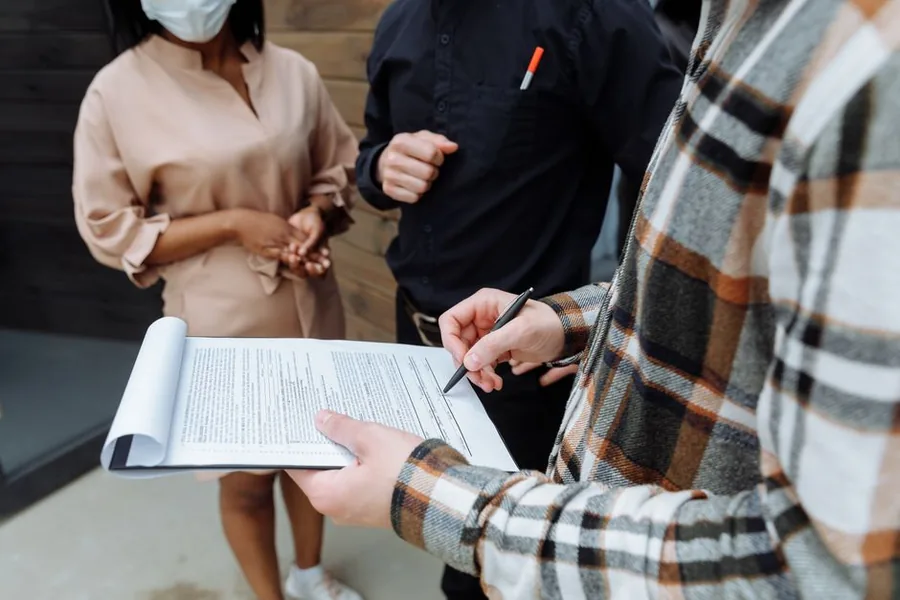 A landlord reviewing and signing paperwork to register for Making Tax Digital ahead of the mandatory deadline A landlord reviewing and signing paperwork to register for Making Tax Digital ahead of the mandatory deadline