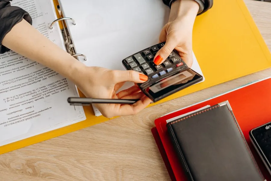 An income statement and an income and expenses notebook laid out for recording a small business's day to day transactions