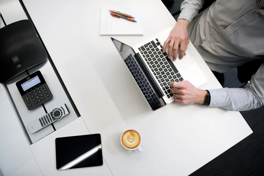 Desk with receipts, bank statements and a laptop showing UK bookkeeping software