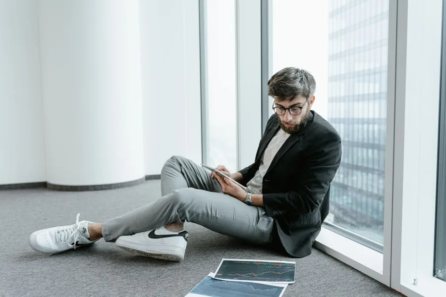 A business owner reviewing figures on a tablet while weighing up switching from sole trader to a limited company A business owner reviewing figures on a tablet while weighing up switching from sole trader to a limited company