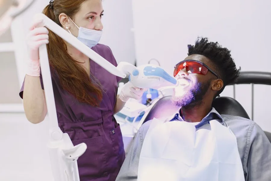 A dental professional carrying out a cosmetic teeth whitening treatment, the kind of procedure that is standard-rated for VAT A dental professional carrying out a cosmetic teeth whitening treatment, the kind of procedure that is standard-rated for VAT