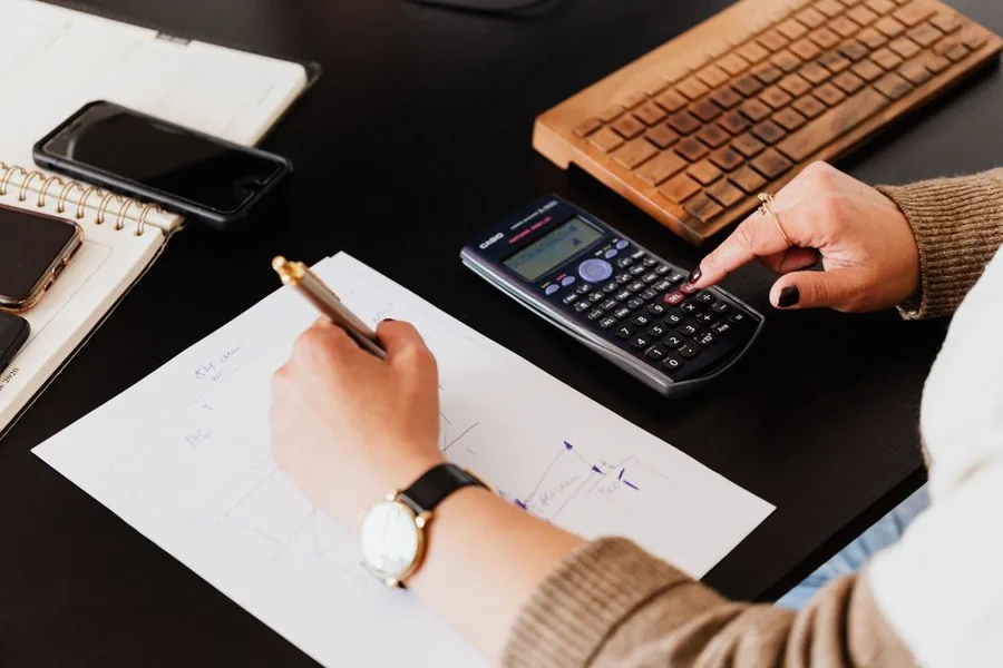 An accountant using a calculator to work out writing down allowance and capital allowance figures on a business asset schedule An accountant using a calculator to work out writing down allowance and capital allowance figures on a business asset schedule