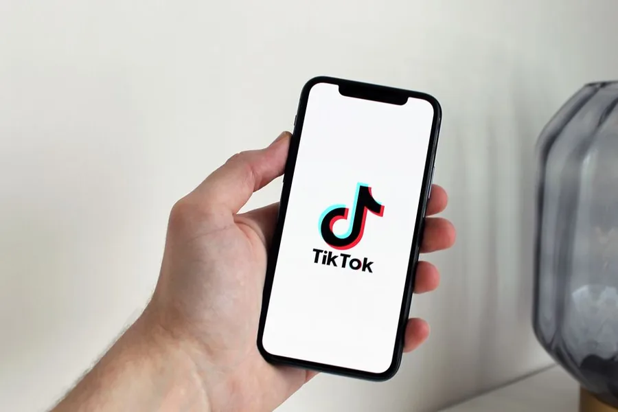 A smartphone showing the TikTok app, held ready to check affiliate commission earnings for a UK Self Assessment return A smartphone showing the TikTok app, held ready to check affiliate commission earnings for a UK Self Assessment return