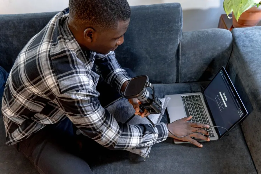 A UK content creator setting up a camera and laptop to film affiliate videos while weighing whether to go limited
