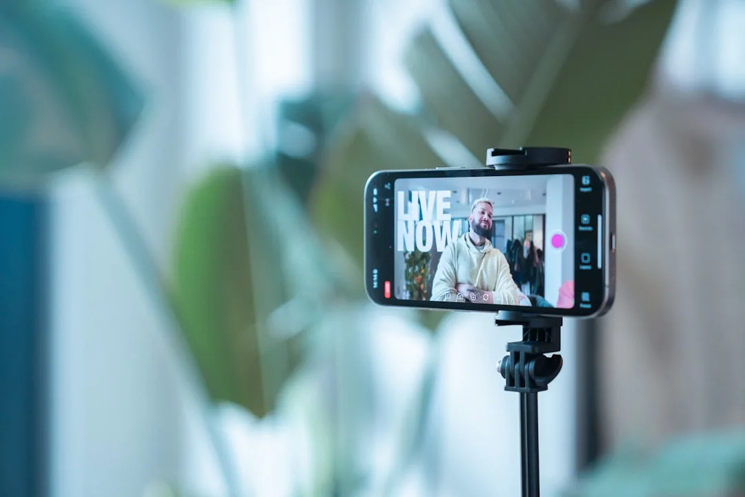A UK content creator filming a product video next to a laptop showing TikTok Shop sales