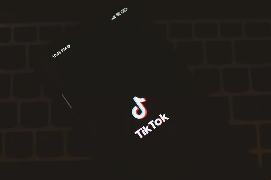 A hand holding a smartphone showing the TikTok app, where UK sellers run their TikTok Shop storefronts and take payouts A hand holding a smartphone showing the TikTok app, where UK sellers run their TikTok Shop storefronts and take payouts