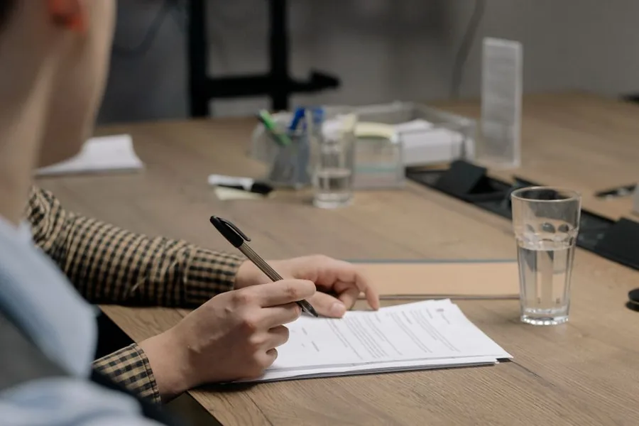 A director signing the paperwork to transfer personal assets into a newly formed UK limited company A director signing the paperwork to transfer personal assets into a newly formed UK limited company