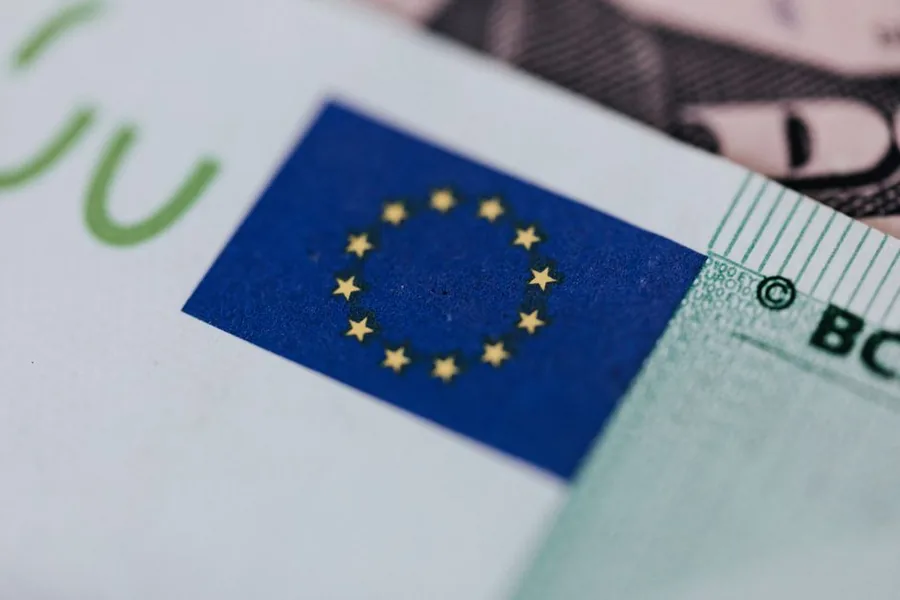 A euro banknote showing the EU flag emblem, illustrating the VAT charged on ecommerce sales into the European Union. A euro banknote showing the EU flag emblem, illustrating the VAT charged on ecommerce sales into the European Union.