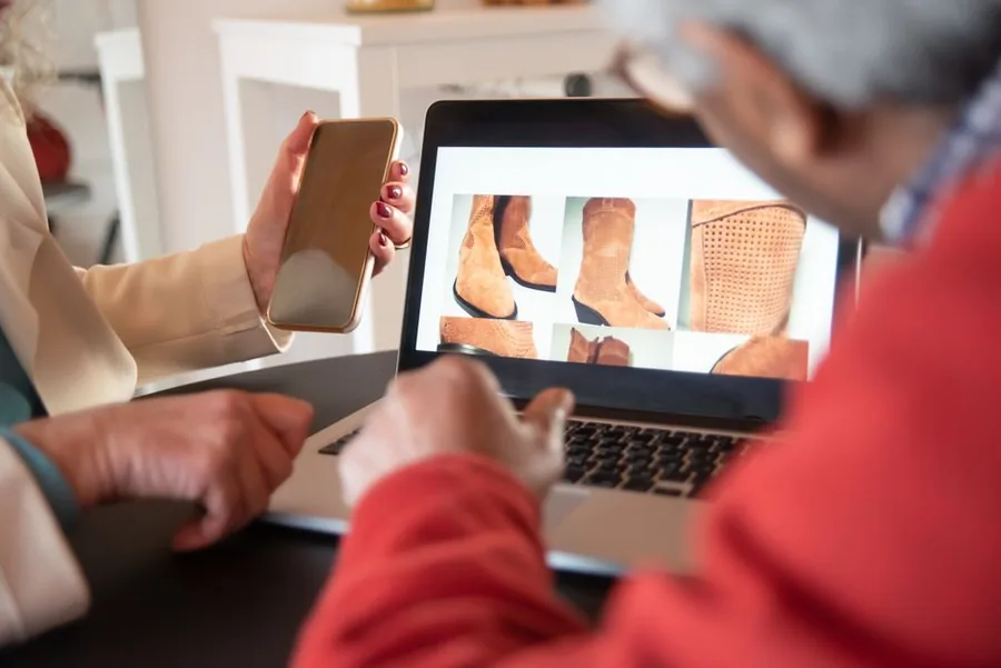 Shoppers browsing an online store's product listings on a laptop, the kind of US sales that can trigger economic nexus Shoppers browsing an online store's product listings on a laptop, the kind of US sales that can trigger economic nexus
