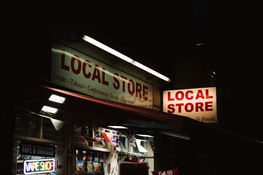 A UK local store sign advertising vape and tobacco products, a typical retailer affected by Vaping Products Duty