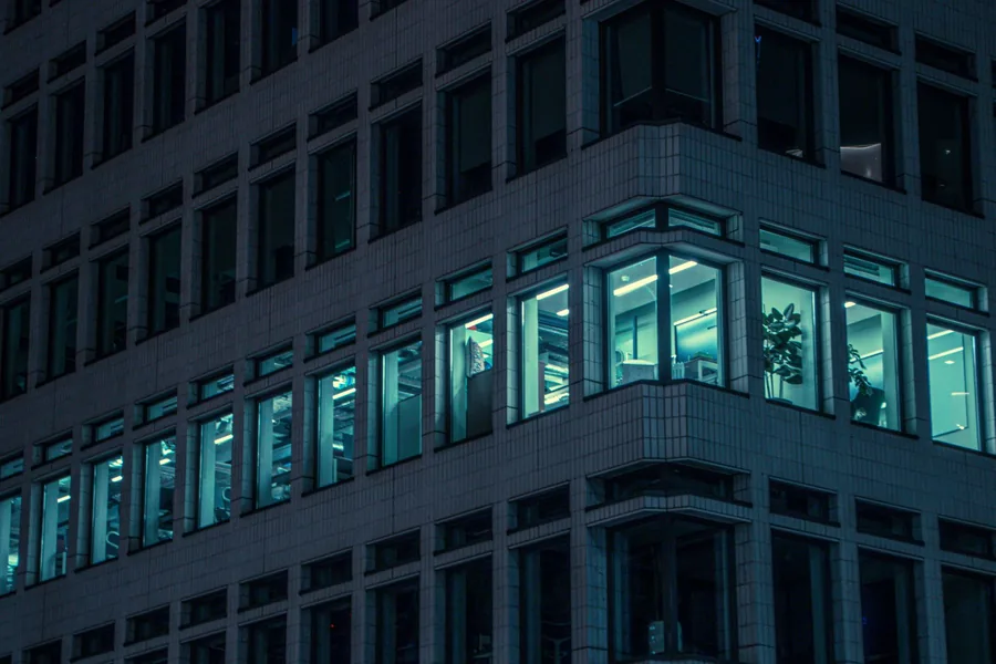 Corner of a city centre office block at night with lit floors, the type of commercial property caught by the capital goods scheme Corner of a city centre office block at night with lit floors, the type of commercial property caught by the capital goods scheme