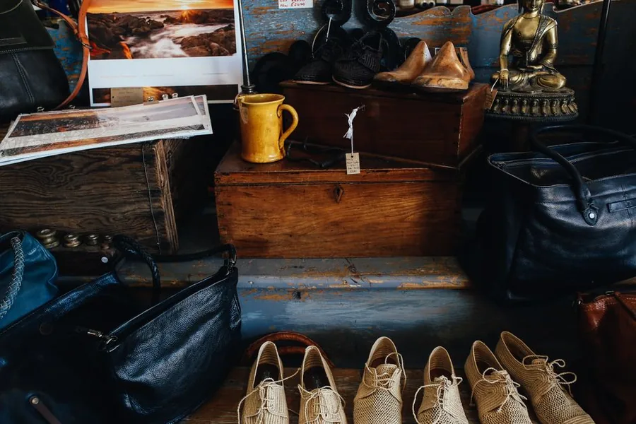 Second-hand leather bags and shoes on display at a UK reseller, the type of resale stock recorded in a VAT margin scheme stock book Second-hand leather bags and shoes on display at a UK reseller, the type of resale stock recorded in a VAT margin scheme stock book