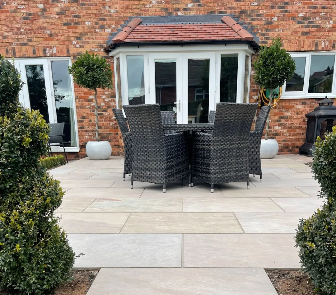 A landscaper laying turf in the garden of a newly built house on a residential development