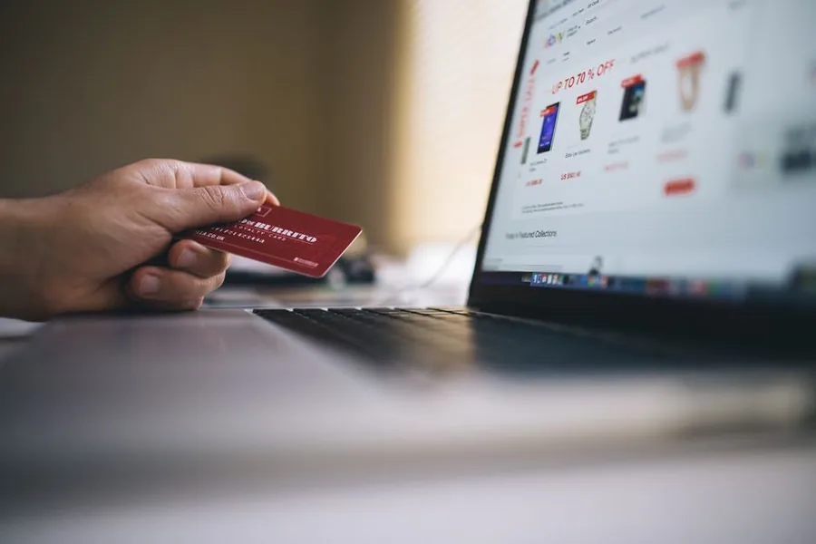 A customer paying by card at an online store, the kind of ecommerce sale that counts towards a seller's VAT threshold A customer paying by card at an online store, the kind of ecommerce sale that counts towards a seller's VAT threshold