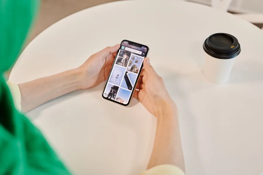 Photographing a flat lay of second-hand clothes on a phone to list them for sale online Photographing a flat lay of second-hand clothes on a phone to list them for sale online