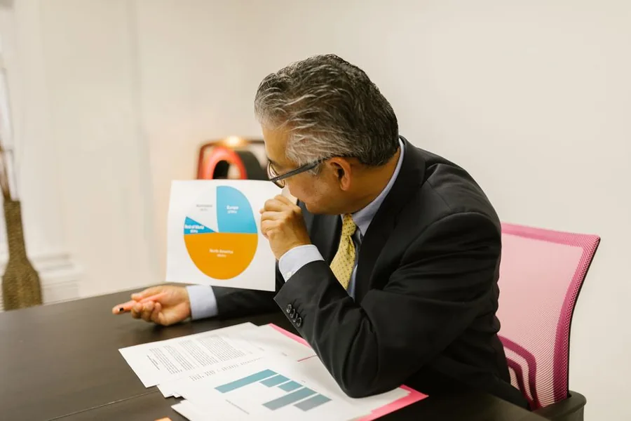 A senior finance leader reviewing strategic performance charts, the kind of oversight a fractional CFO brings to a growing UK business A senior finance leader reviewing strategic performance charts, the kind of oversight a fractional CFO brings to a growing UK business