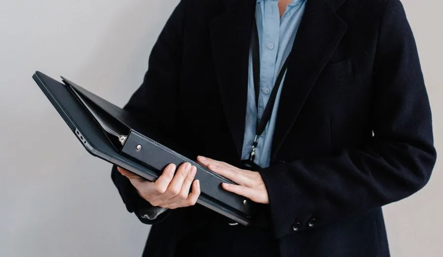 A company director holding a folder of incorporation documents ready to register a new limited company with Companies House A company director holding a folder of incorporation documents ready to register a new limited company with Companies House