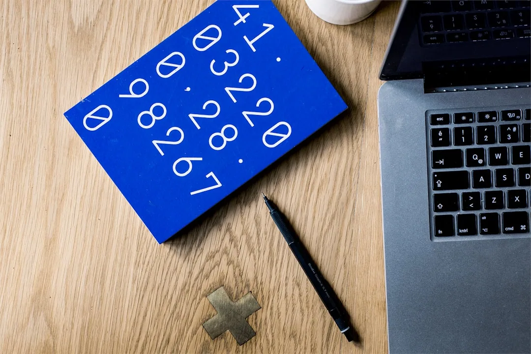 UK employee checking a payslip to find their payroll number near their name and tax code