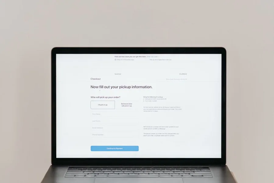 A laptop showing an online store checkout screen, the point where a WooCommerce shop applies VAT to a digital download sale