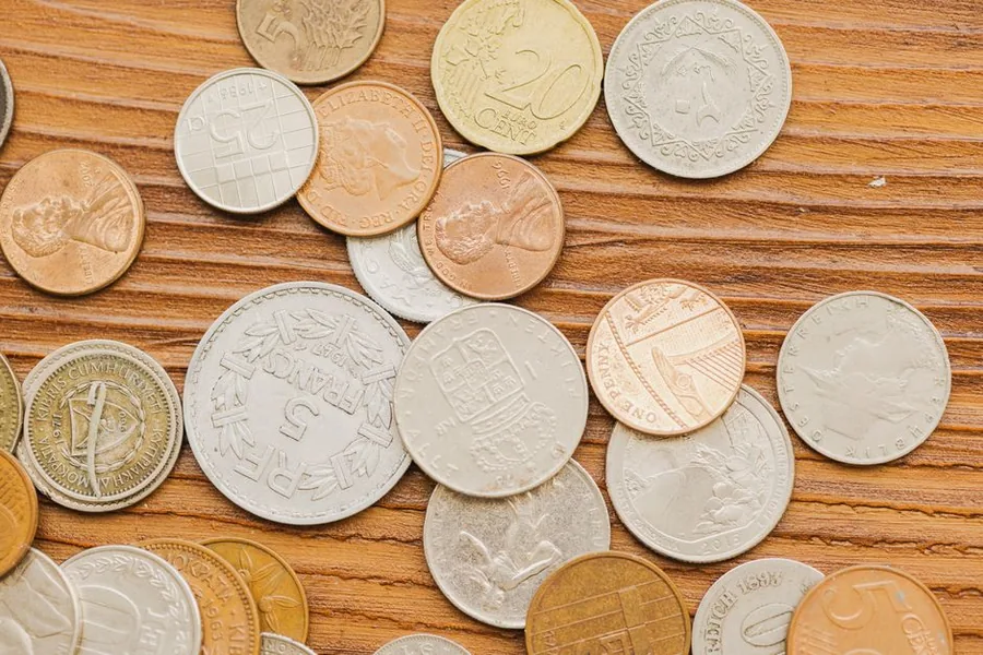 A mix of international coins including a British penny, reflecting the multiple currencies a UK WooCommerce store takes payment in A mix of international coins including a British penny, reflecting the multiple currencies a UK WooCommerce store takes payment in