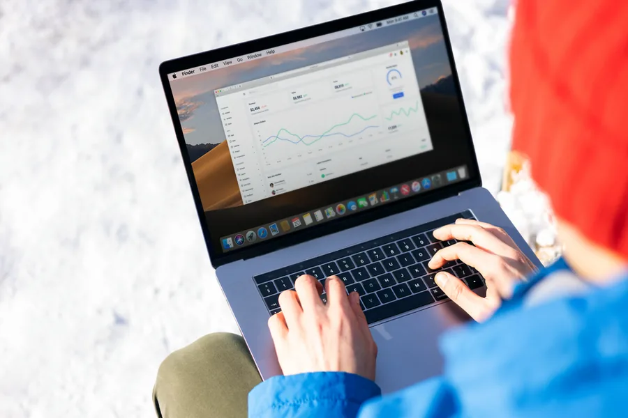 Reviewing cashflow and revenue charts on a cloud accounting dashboard while comparing bookkeeping software options