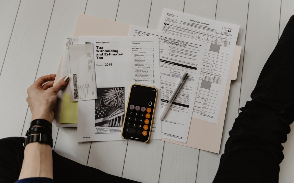 Notebook and calculator on a wooden desk