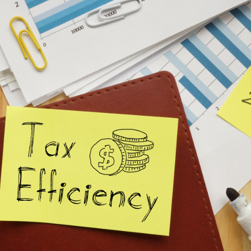 A sticky note with the words "Tax Efficiency" written in a hand-drawn style, accompanied by illustrations of coins and financial charts.