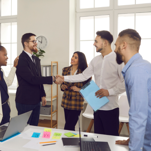 A group of professionals discussing accounting strategies in a casual meeting setting.