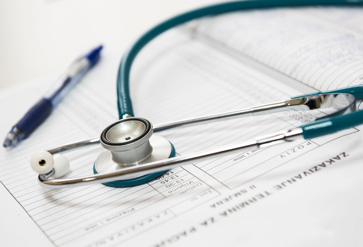 A stethoscope placed on medical documents, symbolizing healthcare professionalism.