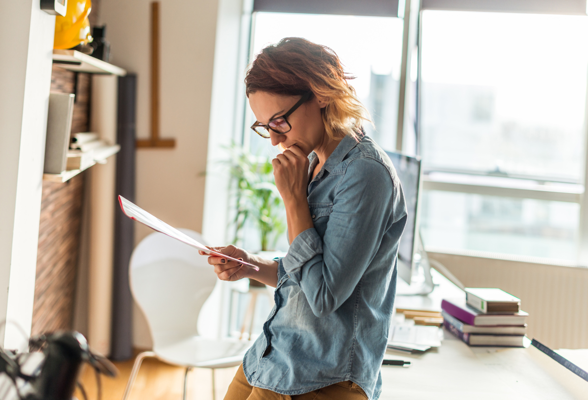 Businesswoman stressed while reviewing documents