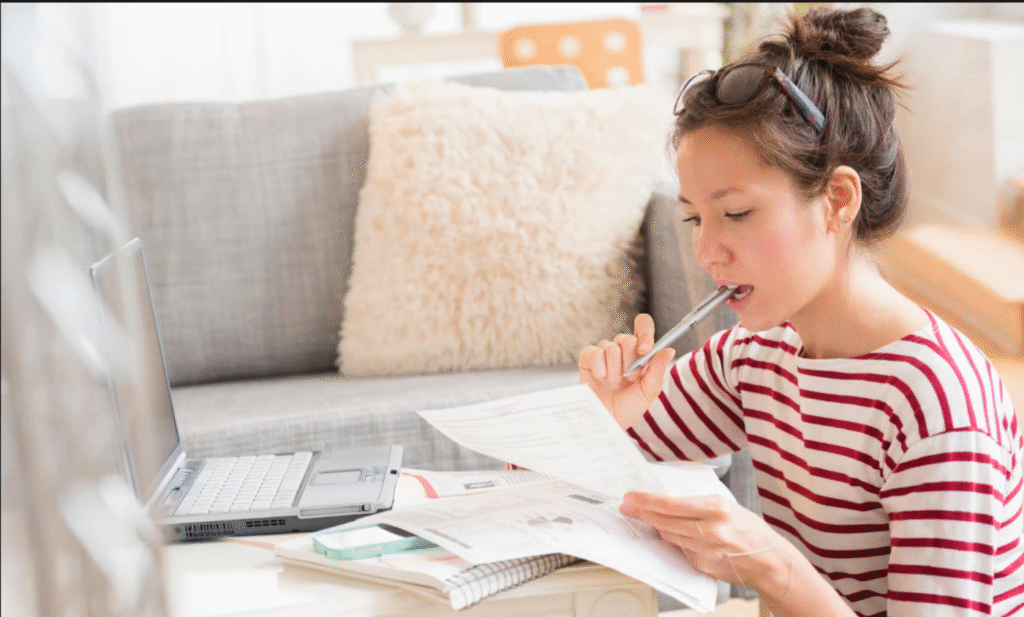 A Accountant reading and writing in a notebook.